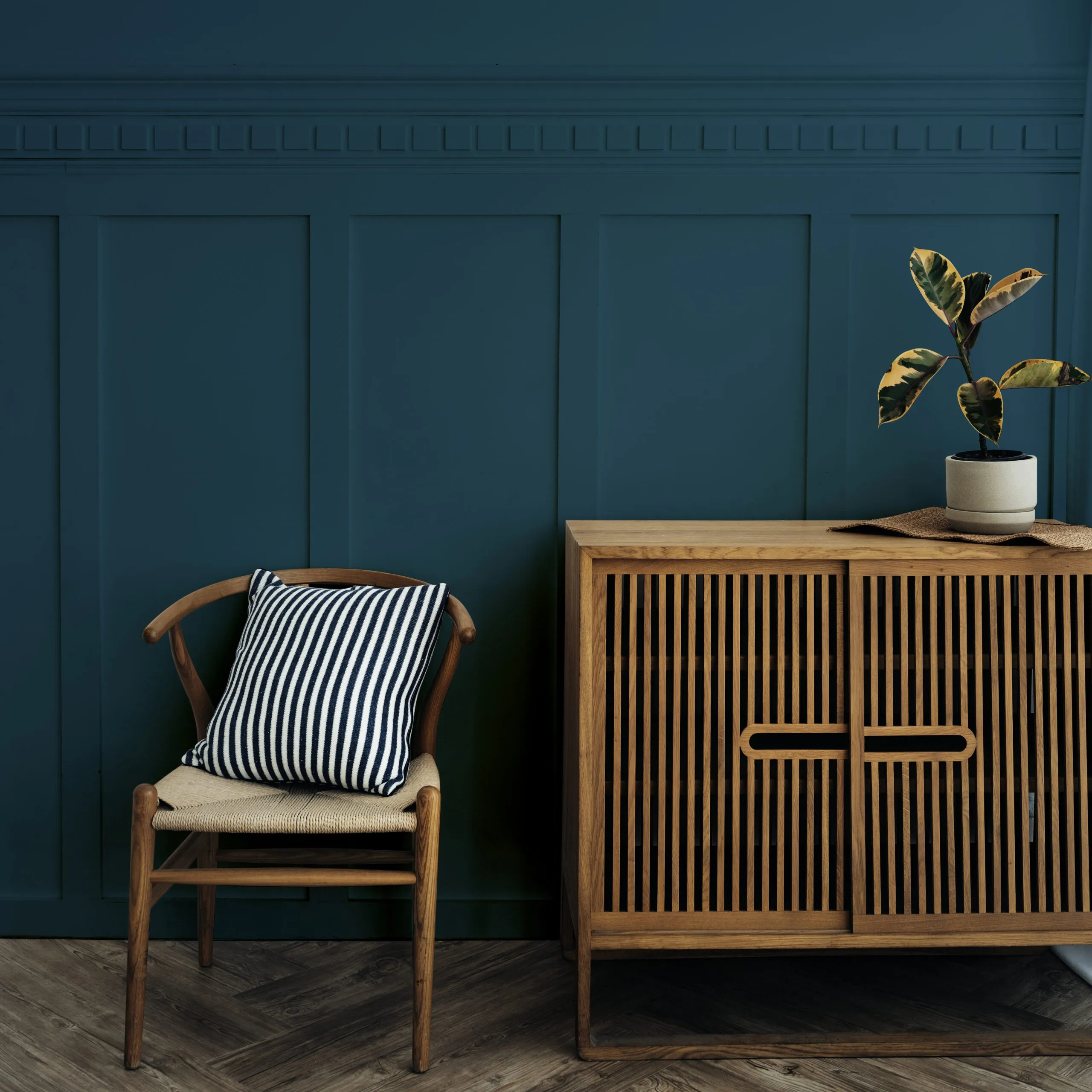 scandinavian vintage wood cabinet with chair by dark blue wall scaled